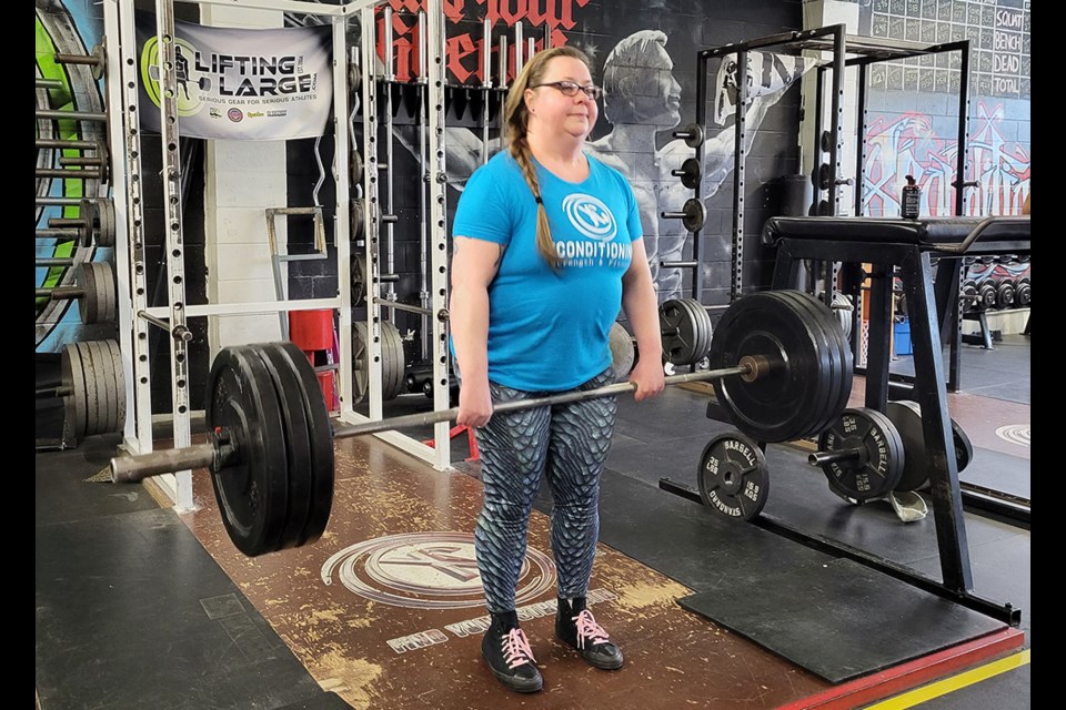 Canadian record-holding powerlifter Tina Lamarsh, 51, prepares for her deadlift at XConditioning gym in downtown Prince George.