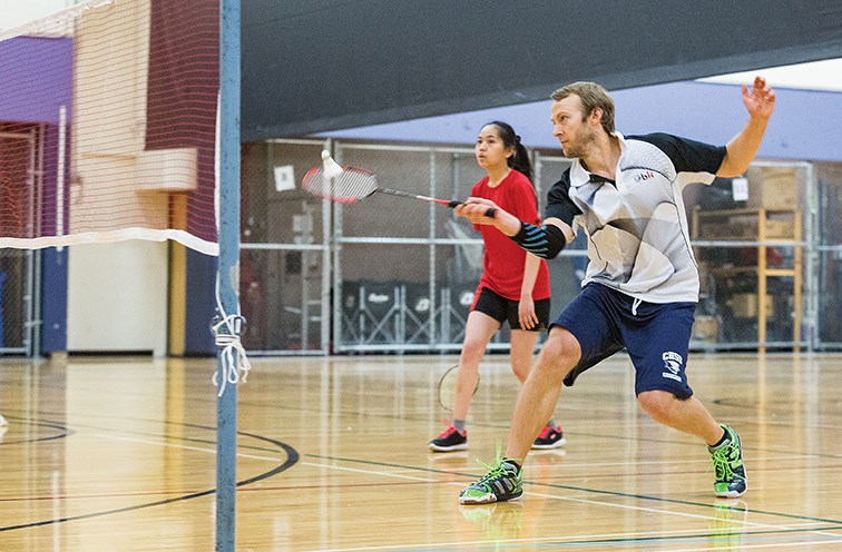 Citizen Photo by James Doyle/Local Journalism Initiative. Chris Wadson hits the birdie over the net while competing in the mixed doubles division of the inaugural IMSS Northern Badminton Smash tournament on Sunday morning at the College of New Caledonia gymnasium.