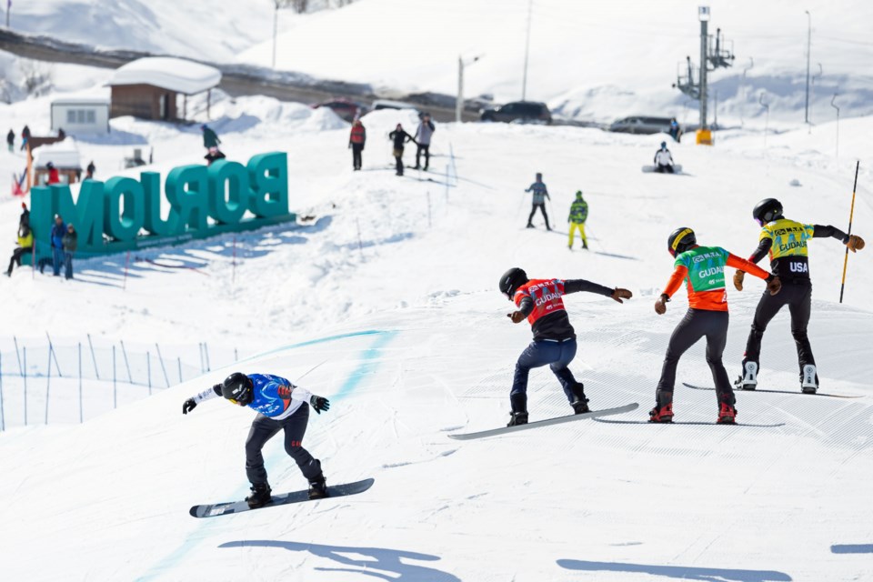 Evan Bichon, left, leads his heat race in a World Cup snowboard cross event April 2, 2024 in Gudauri, Georgia. Bichon placed 12th overall Friday in Montafon, Austria.