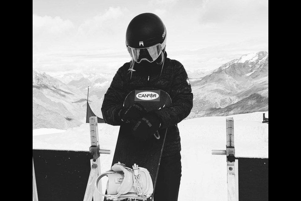 Meryeta O'Dine of Prince George poses with her snowboard while overlooking the 2022 Olympic course at Secret Garden in China.