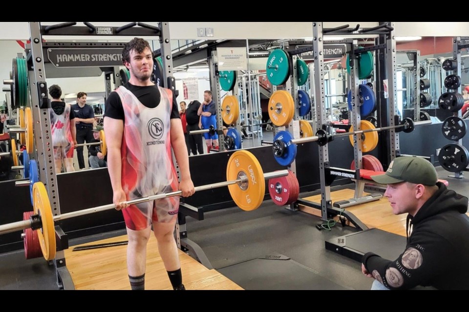 Pierce Northcott from Mackenzie is one of the Special Olympics Region 8 powerlifters who will compete at the BC Summer Games from July 10 to 12 in Prince George. They got together at the Prince George YMCA on Tuesday, May 6, 2025. Coach Bryce Surgenor looking on as Northcott trains.
