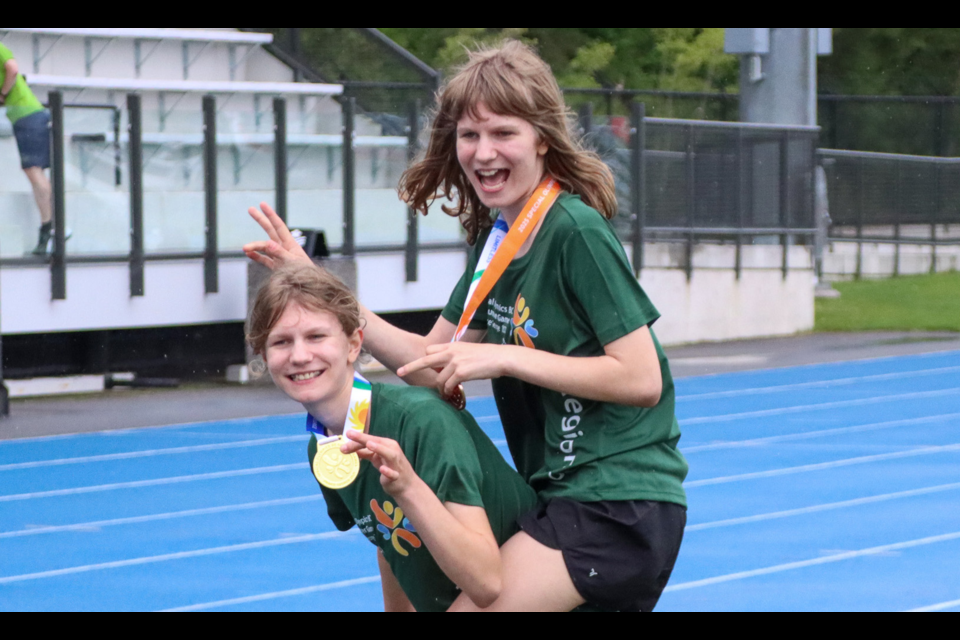 Twins Victoria and Rosy Hogan from Vancouver celebrate their victories during the track and field medal ceremonies on Friday, July 11, 2025 at Masich Place Stadium during the Special Olympics BC Summer Games held in Prince George from July 10 to 12.