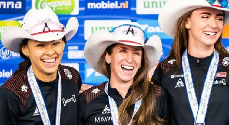 Carolina Hiller, left, joins Ivanie Blondin and Brooklyn McDougall on the ISU World Cup medal podium after they won silver in the team sprint Saturday in Calgary.