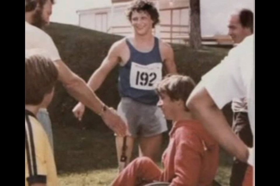 Terry Fox is seen here at the end of the Prince George to Boston Marathon in September 1979, with Rick Hansen in the foreground.