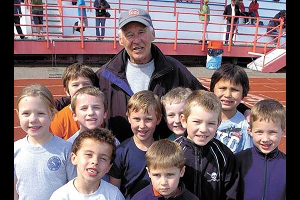 Tom Masich, 86, founder of the Prince George Track & Field Club died on Sunday. Here he is seen in 2010 with a group of children he was coaching.
