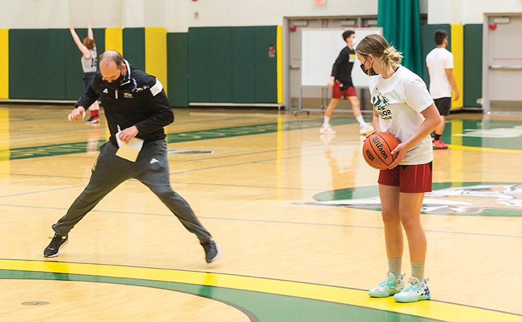 Citizen Photo by James Doyle/Local Journalism Initiative. Men's basketball coach Todd Jordan demonstrates a drill on Sunday afternoon at Northern Sport Centre during the Grade 10-12 Elite session of the UNBC Timberwolves May Long Weekend basketball camp.