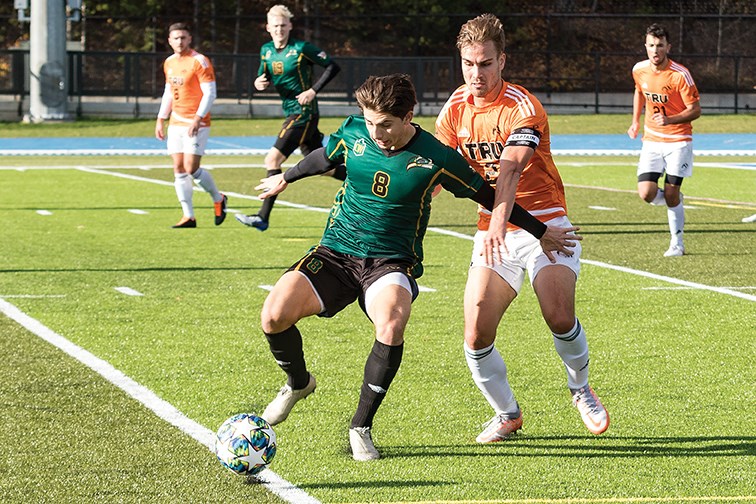 UNBC Timberwolves defender Cody Gysbers protects the ball from TRU Wolfpack defender Jan Pirretas Glasmac on Saturday afternoon at Masich Place Stadium during the Timberwolves first annual Nats'ilnik Day game on Oct. 23, 2021. Gysbers has been named ti the TWolves' Wall of Honour.