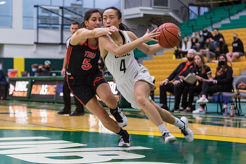 Citizen Photo by James Doyle/Local Journalism Initiative. UNBC Timberwolves player Lucy Guan drives hard to the net against TRU Wolfpack defender Kelsey Cruz on Friday night at Northern Sport Centre during the Timberwolves home opener. 