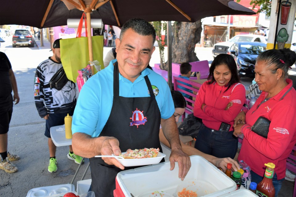 Moses serves up tostadas from the Moy Ceviche street cart.