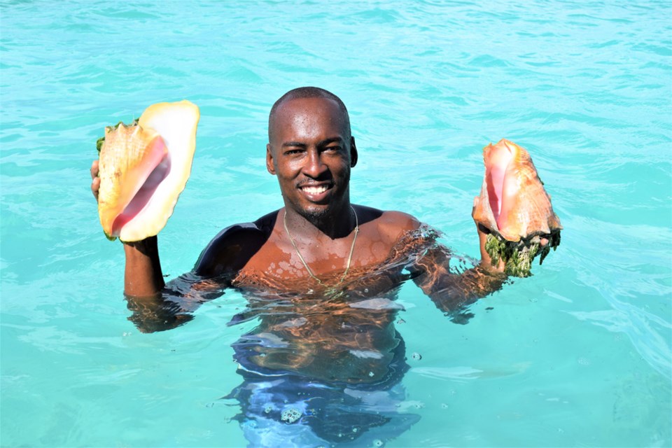 Captain Calson ‘Rice’ Williams shows off some of the conch catch.