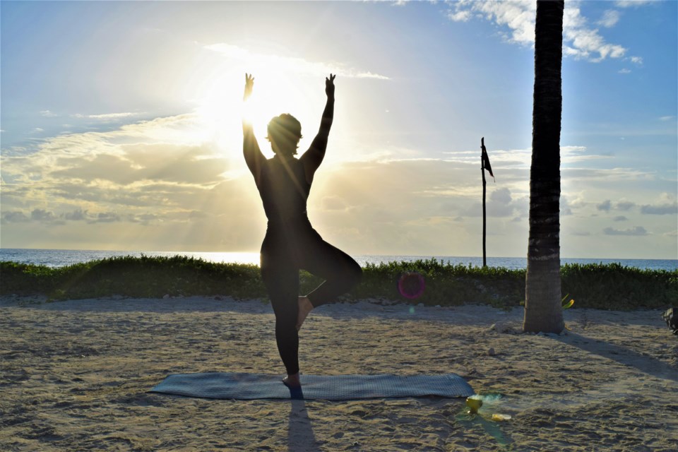 Yoga instructor Pamela Caceres strikes a pose at sunrise at the Hilton Tulum All-Inclusive Resort.