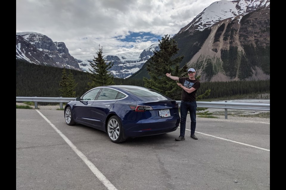 Tesla Model 3 owner Mark Vejvoda points to the spectacular Jasper National Park scenery while on a trip from Prince George with his electric car. Vejvoda, a member of the Prince George Electric Vehicle Association, plans to attend an open-house event at The Exploration Place parking lot to share his experiences about owing and operating an EV in a cool northern B.C. climate.