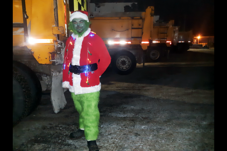 City of Prince George roads foreman Jason Hladchuk gets into the spirit of Christmas as he stands next to the city's fleet of plough trucks at the end of his shift Friday morning.