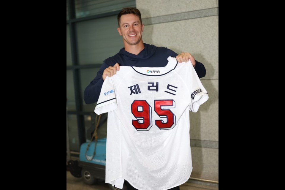 Jared Young of Prince George holds the jersey he wore last summer playing in Korea for the Doosan Bears of the KBO. On Monday, the New York Mets announced they've signed the 29-year-old Young to a one-year contract.