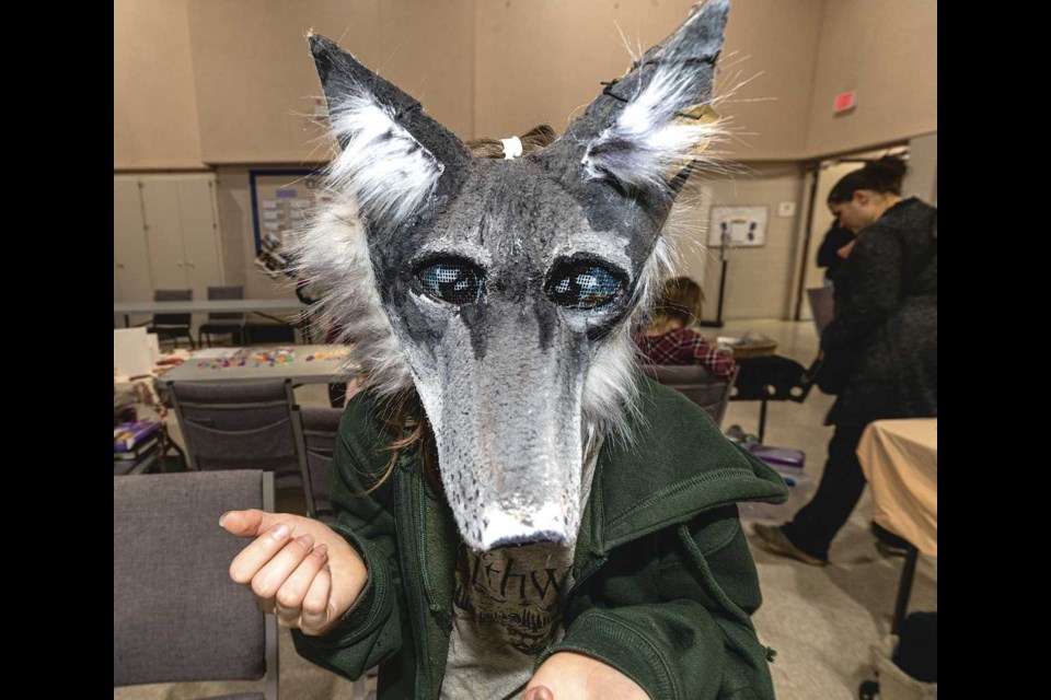 Twelve-year-old Rebecca Flockhart models one of the paper mache masks she makes and sells at her booth at the St. Giles Presbyterian Church Children's Craft Fair, Saturday, Nov. 23.
