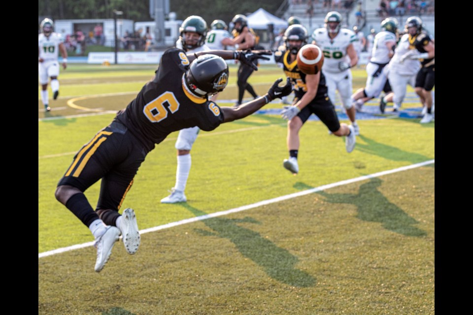Prince George Kodiaks defensive back Jerome Darko twists in the air in an attempt to get his hands on an errant pass from Valley Huskers quarterback Tyran Duval during their game at Masich Place Stadium on Saturday.