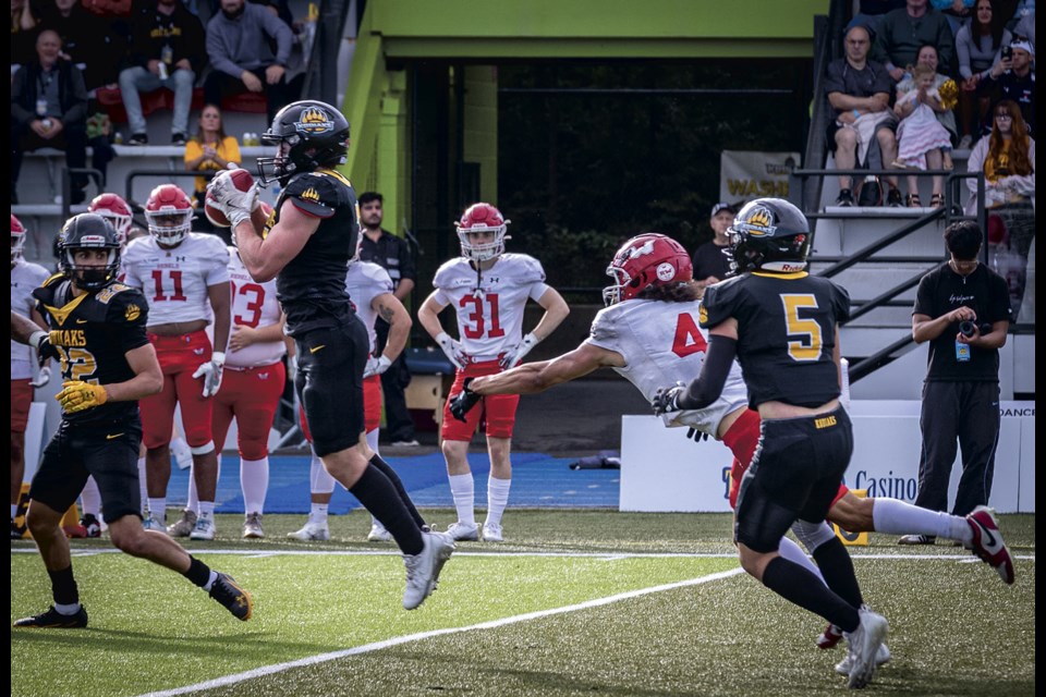 Prince George Kodiaks defensive back Peyton Briere leaps to grab an under thrown pass for an interception during the Kodiaks' season home opener in front of stands full of cheering fans at Masich Place Stadium Saturday, July 19, 2025.