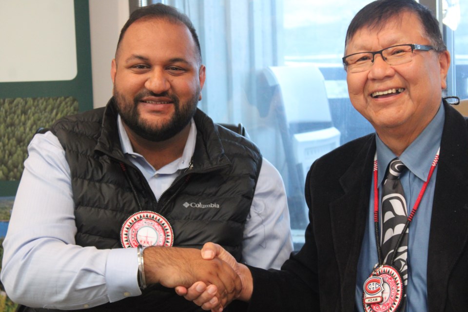 Forests Minister Ravi Parmar and Babine Lake First Nation Chief Wilf Adam shake hands after signing the tenure agreement on Thursday, July 24, 2025 in Burns Lake, BC.