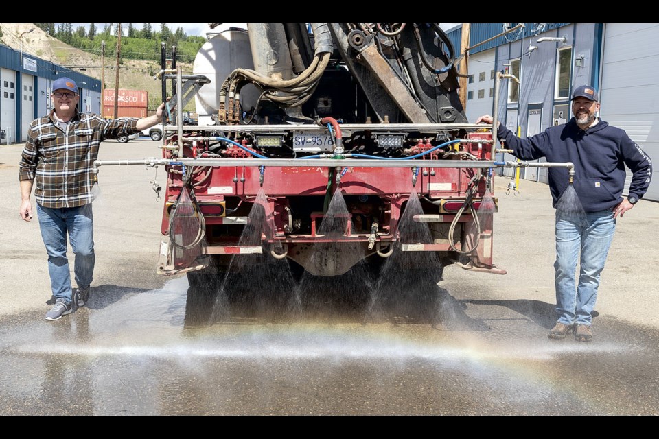 LinkBuild Construction Construction manager Ryan Schuck (left), and general manager Phil Toma demonstrate the spraying abilities of the structural protection unit they have developed to deploy EcoGel fire suppressant and short-term retardant.