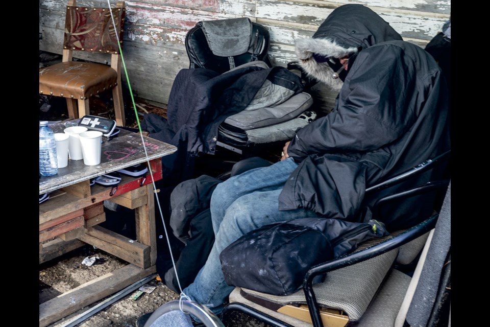 A person, who could be seen moving and breathing, waits in the "coffee area" outside the AWAC warming shelter on Friday, Oct. 11. 