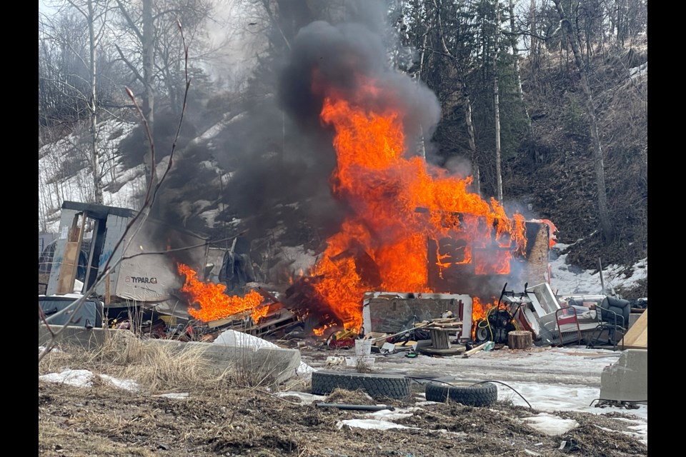 A shack burns at Moccasin Flats on Thursday, March 20, 2025 in Prince George, BC.