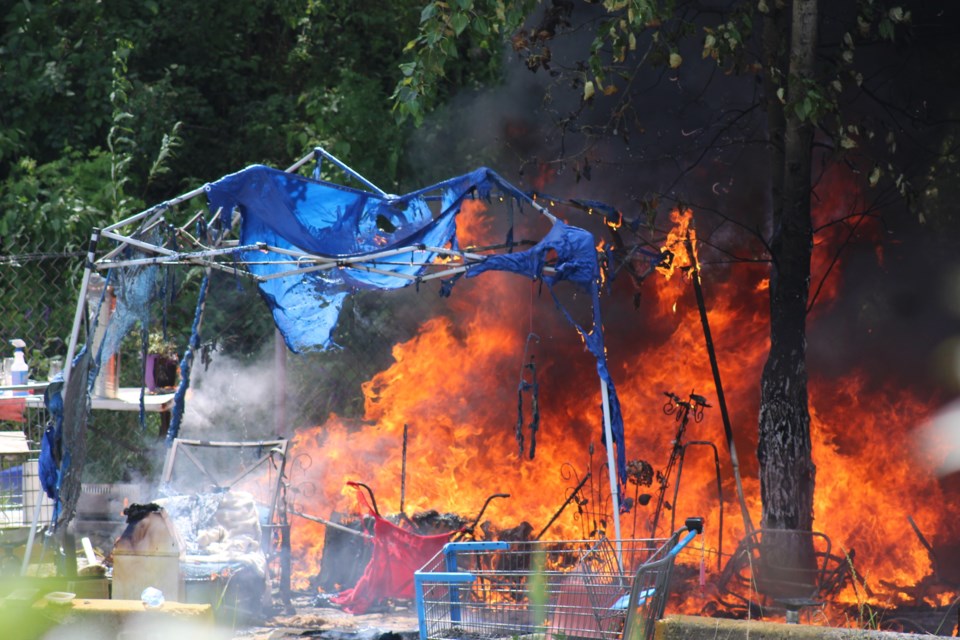 Fire breaks out at a shelter in Moccasin Flats in downtown Prince George on Monday, July 14, 2025.