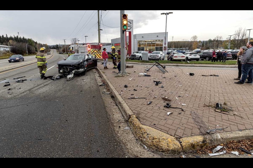 Emergency crews work at the scene of a two-vehicle collision at the intersection of 20th Avenue and Highway 16 west at about 4:20 p.m. Wednesday, Oct. 23, 2024. No life-threatening injuries were sustained, though the driver of one vehicle was attended to by paramedics.