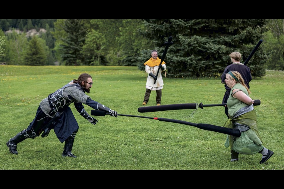 Allurian (Steven Kimberley) reaches to strike Brandy Mcroy (Brenda Morgan) as they do battle during a Northern Grove tournament held at Lheidli T'enneh Memorial Park Sunday, May 25, 2025. Mcroy holds her arm behind her back to indicate that she was hit there and to stop her from using it as the duel continues.