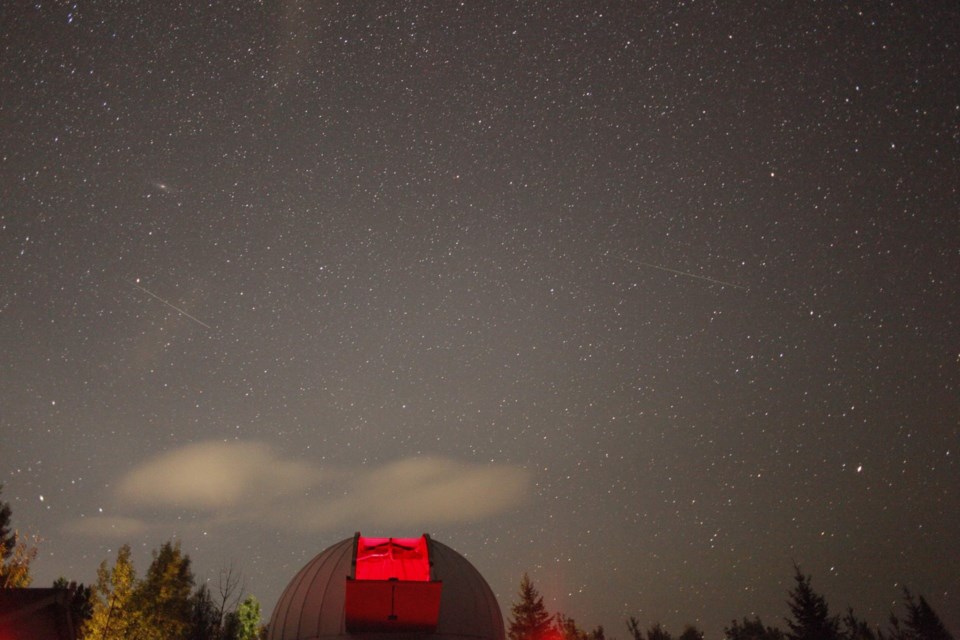 A previous year's Perseid Meteor Shower passes above Prince George, as seen from the Prince George Astronomical Observatory.