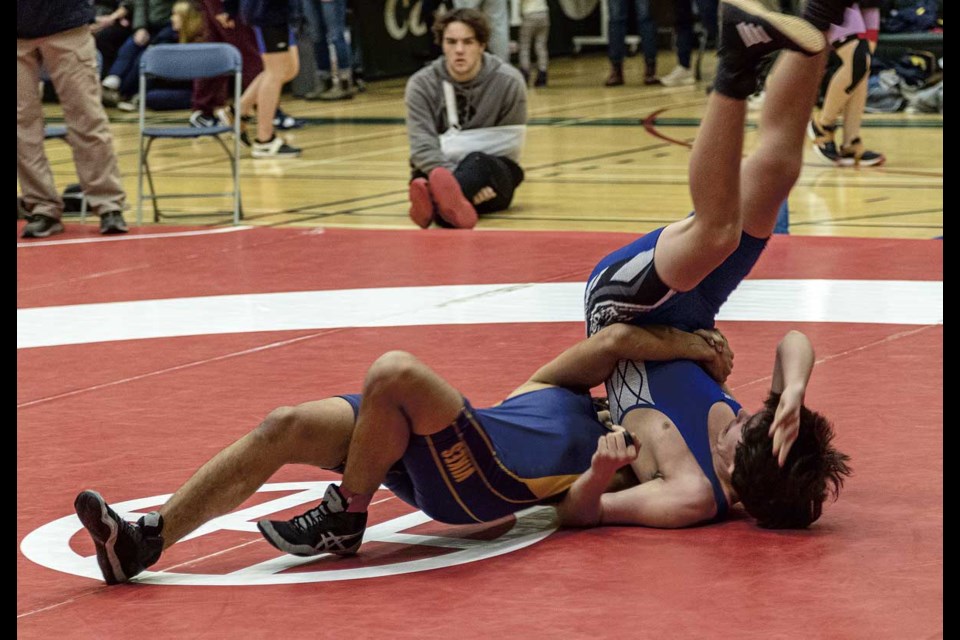 Nechako Valley Secondary School wrestler Jonathon Ruiter of Vanderhoof pulls Shas Ti Kelly Road's Lonnie Cserhazi over onto his shoulders during a 61-64 kilogram match at the PGSS Icebreaker and Pin to Win tournament at PGSS Saturday.