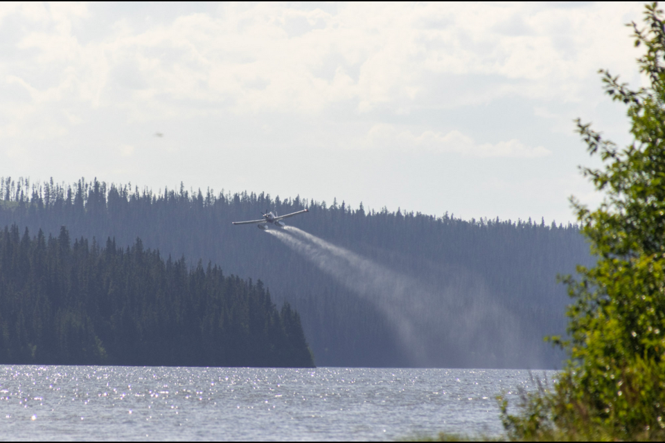 BC Wildfire Service pontoon planes, which can collect lake water and dump it on active fires, operates on Tzenzaicut Lake on Friday, Aug. 1, 2025 near Quesnel, BC.