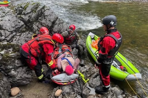 SAR teams prepare to bring a person playing the role of a missing hiker up a rocky cliff beside the Willow River Sunday, Aug. 17.
