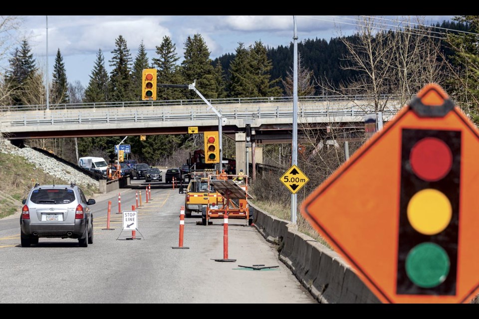 Traffic is controlled by temporary stop lights restricting flow to a single lane under the Simon Fraser Bridge on Ferry Avenue as a YRB crew works to fill a washout that has persisted over the years along the bank under the bridge Thursday, April 24, 2025.