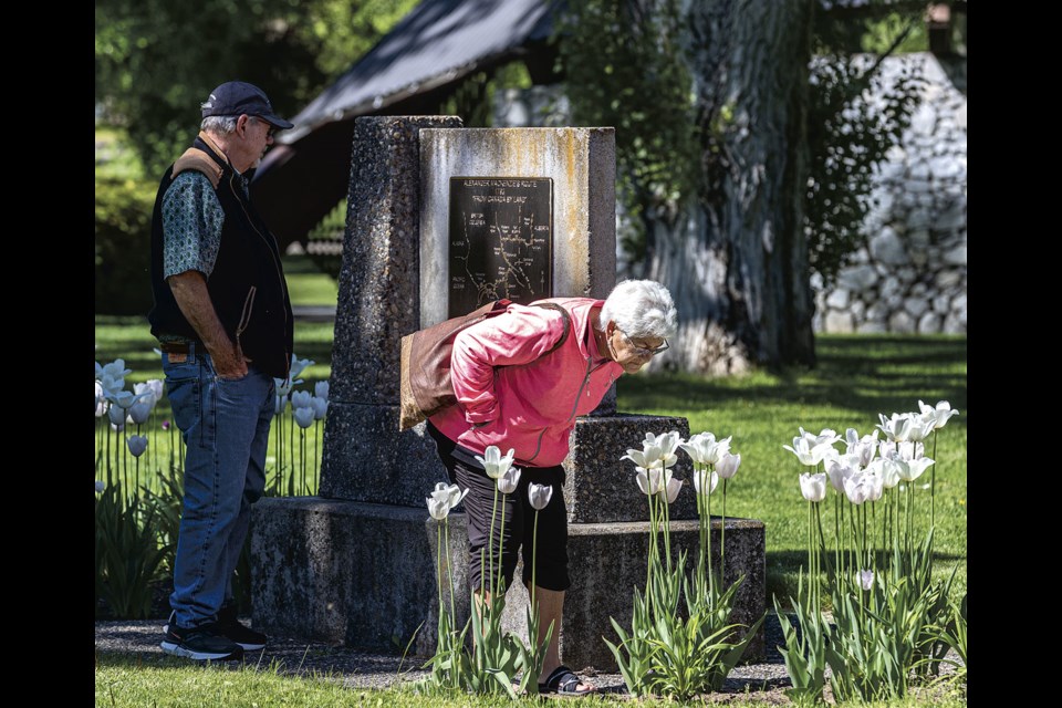 Dave Mehner and Chris Balardo of Vernon enjoy the sunny morning and examine the Alexander Mackenzie commemorative display at Lheidl T'enneh Memorial Park Friday morning after attending their grandchild's graduation from Duchess Park Secondary School Thursday.