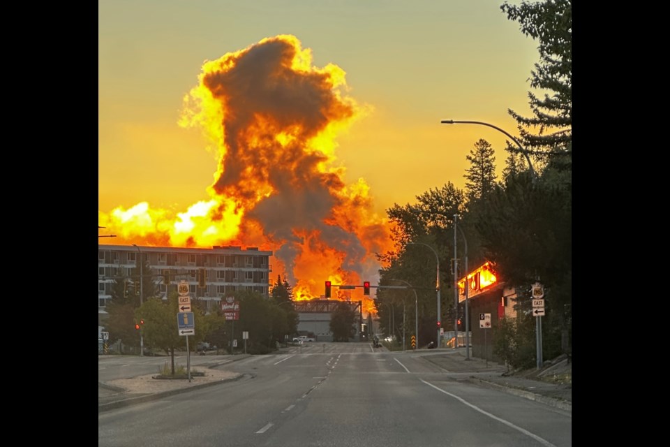 Dashcam photos shot just after 6 a.m. show a brightly lit plume of smoke from the industrial area at the end of Prince George Pulpmill Road rising over the eastern edge of Prince George, BC on Thursday, Aug. 14, 2025.