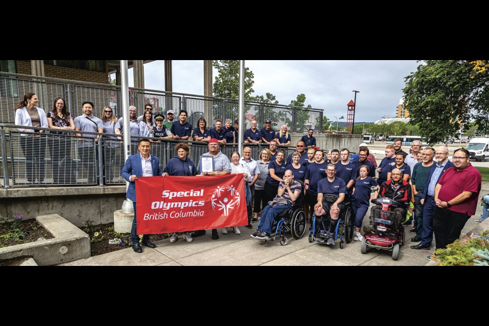 Mayor Simon Yu holds the Special Olympics flag with athlete ambassadors Marinka VanHage and  Adam Spokes after proclaiming July 7-13 as Special Olympics Week in Prince George Monday, July 7, 2025 at City Hall. 