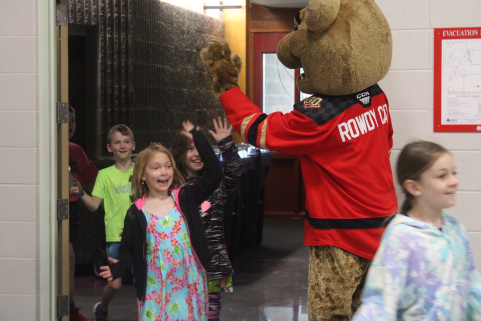 Rowdy Cat high-fives students at Springwood Elementary as they enter the gymnasium On Tuesday, June 10, 2025 in Prince George BC. 