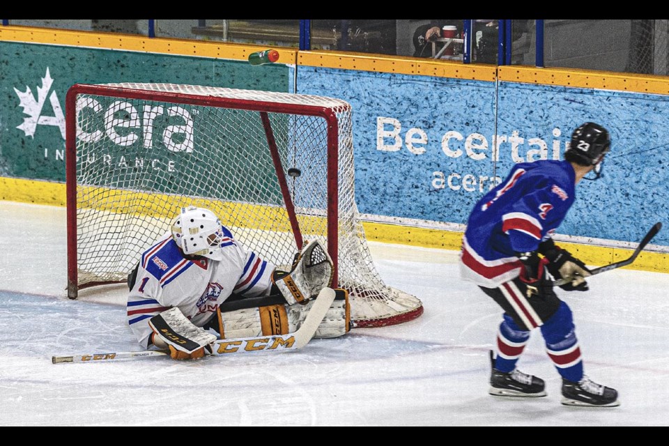 Brandon Manning of the Blue Alumni opens the scoring 2:28 into the first period with a shot into the top of the net over sprawled Alumni White goalie Damien Ketlo Saturday, March 29, 2025 at Kopar Memorial Arena.
