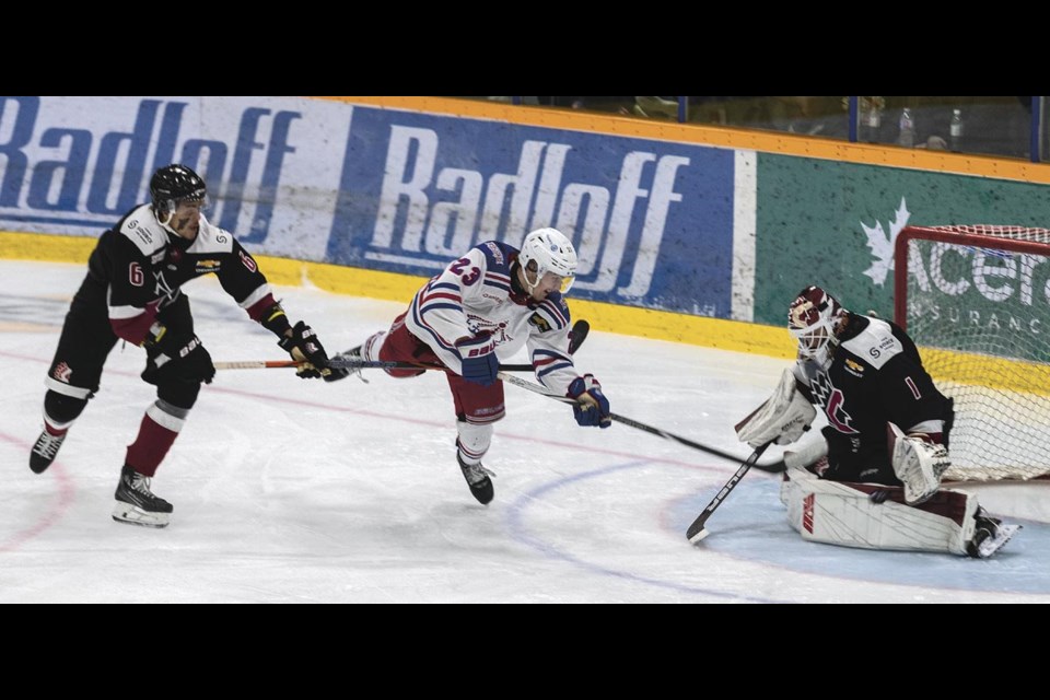 Spruce Kings forward Mason Loewen unleashes a diving backhand shot at Chiefs goalie Quentin Miller as defencseman Jayden Veney attempts to stop him in Game 4 of their BCHL Coastal Conference quarterfinal playoff series Wednesday, April 9, 2025 at Kopar Memorial Arena.
