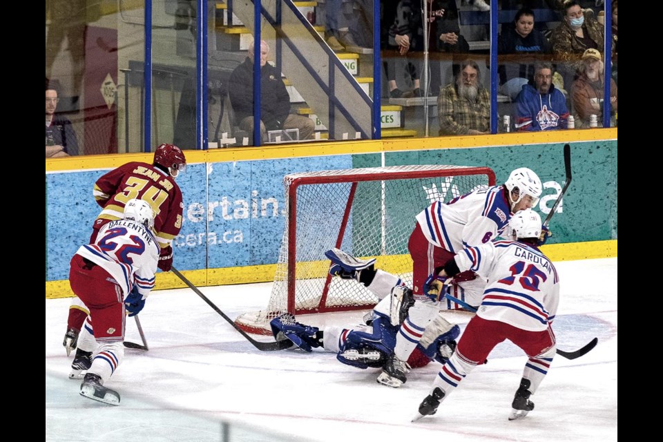 Spruce Kings goalie Charles Gravel puts his glove over the puck and stick of Chiefs forward Dwayne Jean Jr. as he falls back across the crease, stopping the Chilliwack player from flicking the puck into what was an open side of the goal and saving his shutout in Game 6 of their BCHL Coastal Conference quarterfinal playoff series Sunday, April 13, 2025 at Kopar Memorial Arena.
