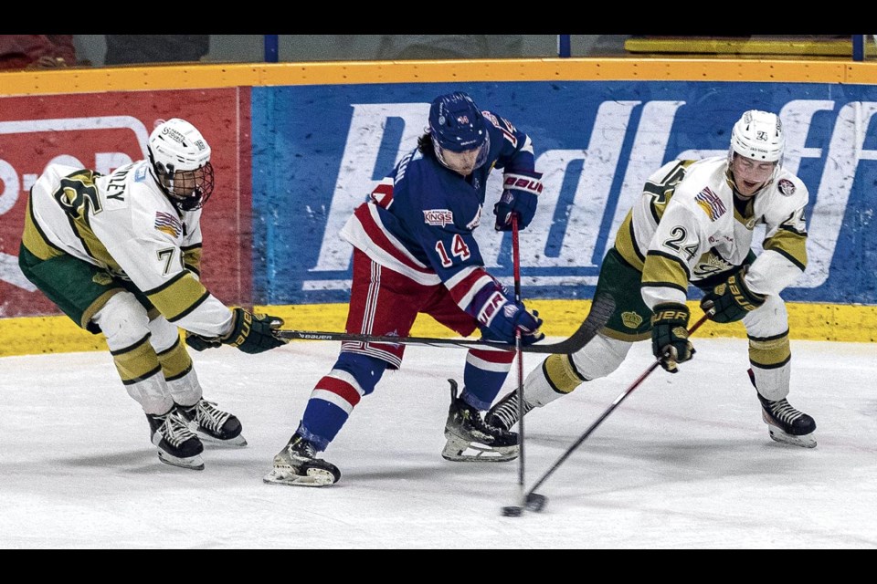 Powell River Kings Nico Bromley (L) and Asher Wites wrestle the puck away from Spruce Kings player Linden Makow Sunday, March 30, 2025 at Kopar Memorial Arena.