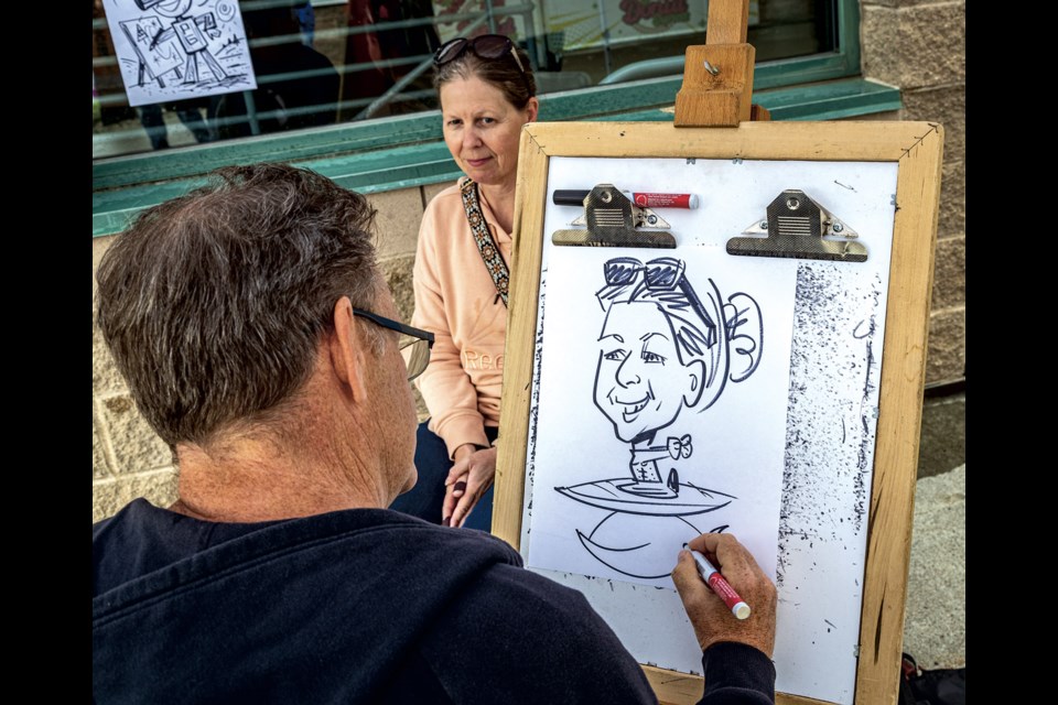 Sheryl Benningfield of Quesnel sits for a free caricature by Ted Couling at the BCNE Saturday, August 16, 2025.