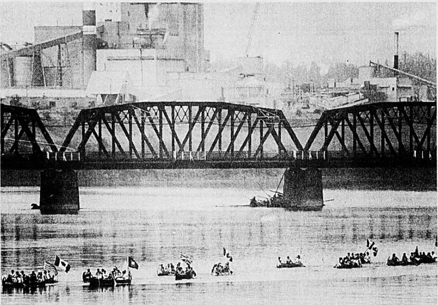 Aug. 1, 1985: Members of the B.C. Heritage Brigade, dressed in period costumes, are dwarfed by the Fraser Bridge and pulp mill as they paddle the route used by fur brigades in the 18th and 19th centuries. They raised their paddles to greet the more than 200 people on shore who watched them as they travelled from Fort St. James to Fort Langley.