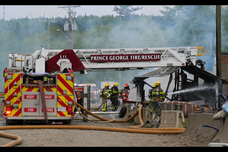 Firefighters battle a blaze at Moccasin Flats on Thursday, May 30, 2024 in Prince George, B.C. It was the second fire at the homeless encampment on Lower Patricia Boulevard this week.