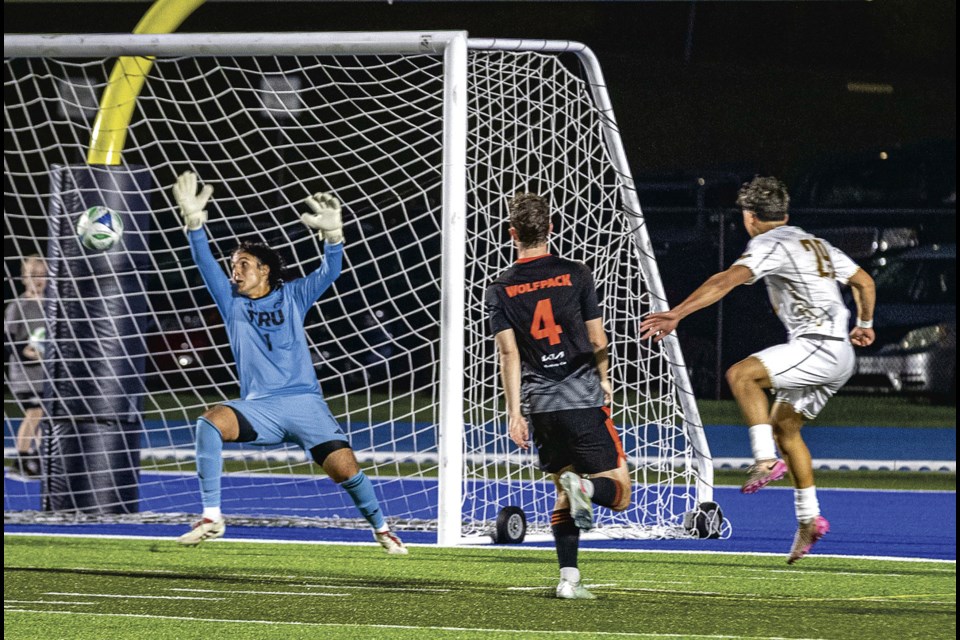 UNBC Timberwolves defender Jamie Wildash-Chan turns and fires a shot past TRU Wolfpack goalie Luca Ortu to put the Timberwolves ahead 2-1 during their season opening game at Masich Place Stadium Friday, August 22, 2025.