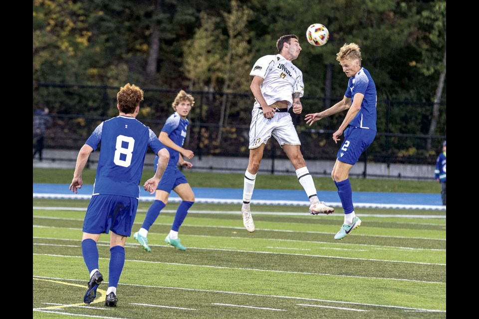 UNBC Timberwolves midfielder Connor Lewis battles with UVIC Vikes defender Fin Tugwell for a header as the two teams fought to 0-0 tie Friday at Masich Place Stadium. 