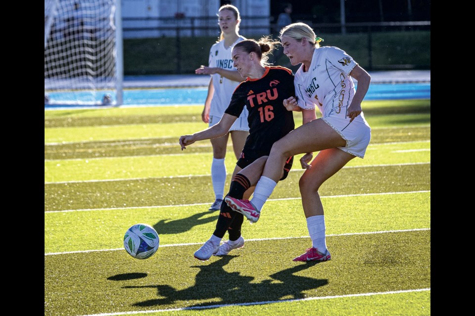 Timberwolves midfielder Laney Stewart battles with TRU midfielder Sophia Branby for control of the ball during their season opening game at Masich Place Stadium Friday, August 22, 2025.