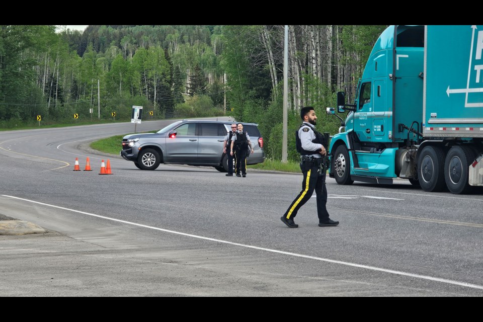 Prince George RCMP officers set up at the intersection of Highway 16 and Upper Fraser Road west of the city on Tuesday, May 27, 2025. The highway was closed as police, including an emergency response team, dealt with a developing situation.