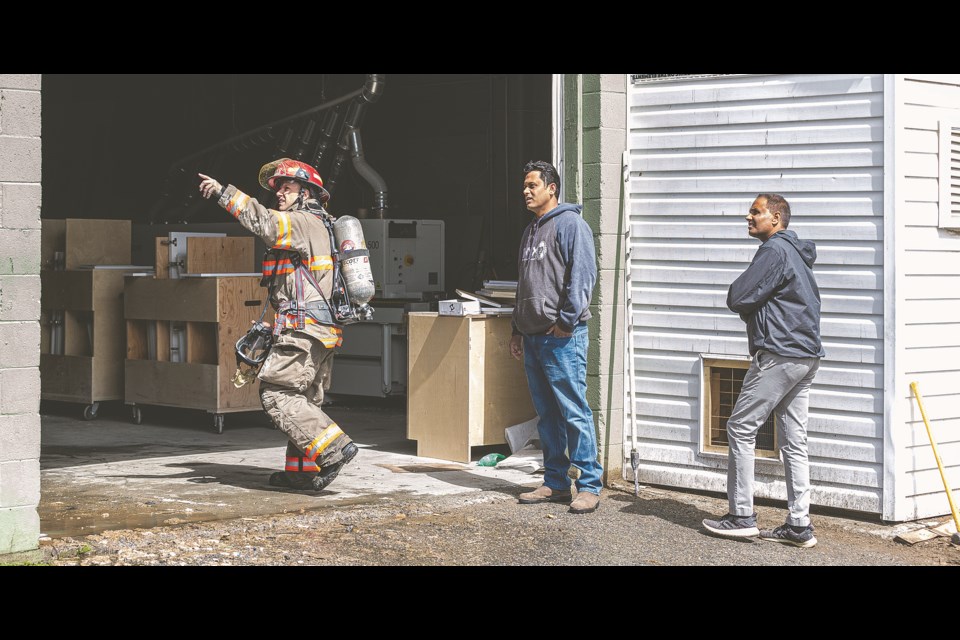 Prince George Fire Rescue Capt. Halovich shows Onyx Stone & Custom Cabinets owner Bikram Sahi the damage caused by an apparent sawdust fire Sunday. The three attending engines received the call at noon and found the shops dust collection system engulfed. Sahi estimated the damage at $300, 000 or more depending on damage to machinery.
Citizen photo by Chuck Nisbett