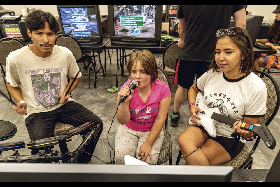 Brennan Mckinnon (left), Elora Chmielnicki, 8, and Louisa Alfred got together for a game of Rock Band during the VGPG Expo Sunday, August 24, 2025 at the House of Ancestors.